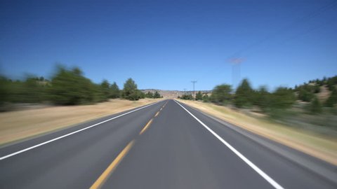 High-speed driver's POV of Highway 20 through high desert near Burns, Oregon