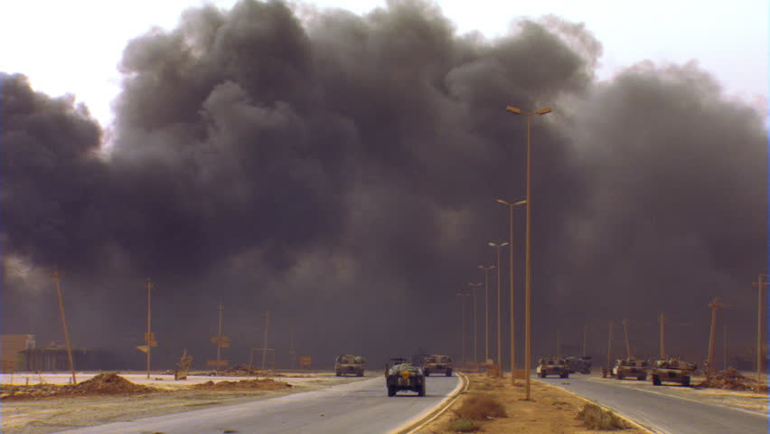 Military vehicles waiting while Iraqi roadway is cleared