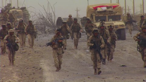 Marines advancing toward Baghdad, accompanied by armored vehicles