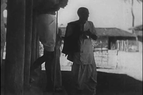 1930s: Mahatma Gandhi leads the Dandi Salt March to protest the taxation of the British Raj and, at the sea, distilling salt with peasant protestors, he is arrested, in 1930.