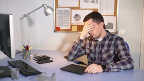 Stress work in the office. Young male businessman has a headache because he work hard to earn more money. - Powered by Shutterstock - Get 15% off with code: PIKWIZARD15