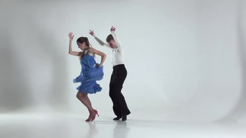 Couple is ballroom dancing on white background, shadow. Slow motion