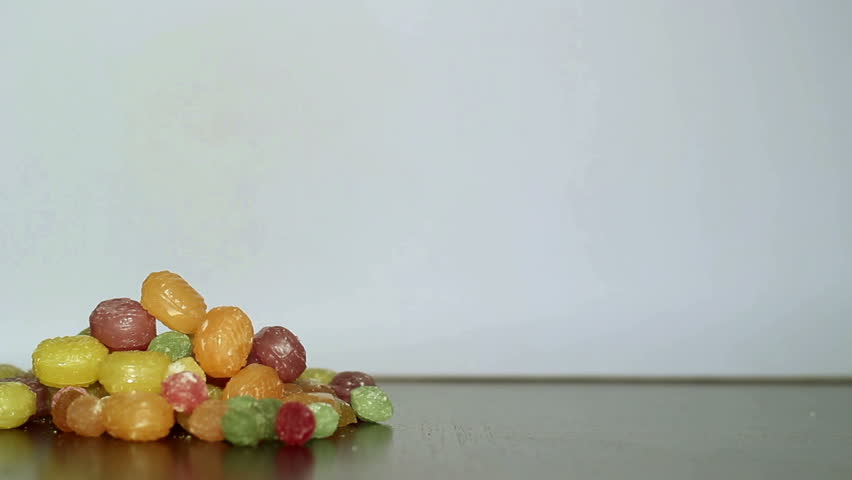 Colorful candies and white sugar. 