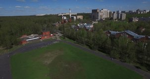 Aerial drone video with view of sport stadium area of Moscow Kuntsevo district, sports fields buildings, power station chimneys, old houses and surroundings in western side of the capital of Russia