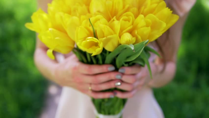 Woman carrying bouquet of tulips Royalty-Free Stock Footage #26740921