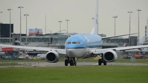 SCHIPHOL, AMSTERDAM, THE NETHERLANDS - MAY 5: KLM Boeing 737 passenger plane taxiing to the runway on May 5, 2017 in Schiphol, Amsterdam, the Netherlands.