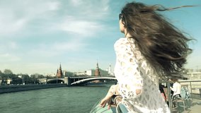 Young brunette woman watching at Moscow Kremlin. Travel to Russia concept. Slow motion video