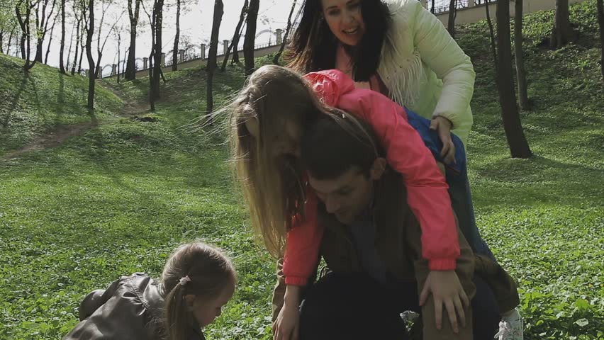 The family plays with the child on a beautiful sunny day
