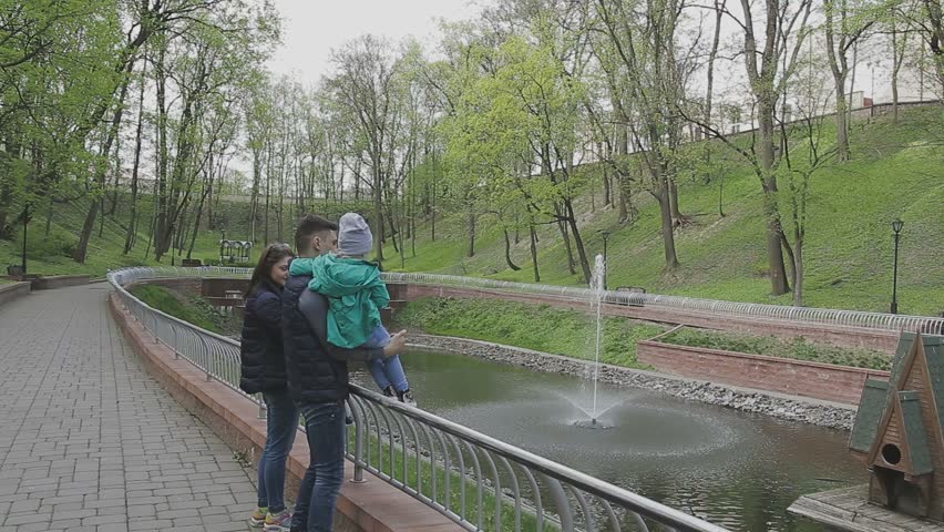 The family plays with the child on a beautiful sunny day