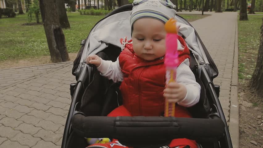 Mom walks with the child on a beautiful sunny day