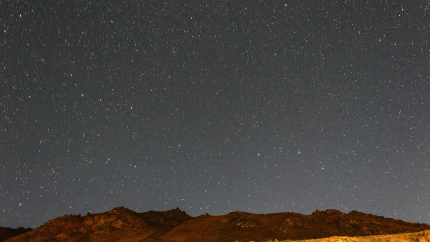 Traces from stars in the form of evanescent traces. Milky Way over the mountains. UltraHD (4K)