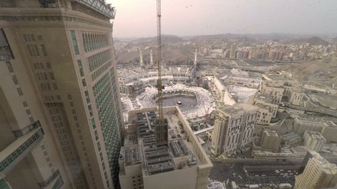 Mecca, Saudi Arabia - September 15, 2016: Time lapse video of Kaaba from a hotel room as the day turn to evening. Muslim believers pray the evening prayer and circle around the Kaabah.