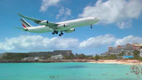 PHILIPSBURG, ST. MAARTEN - 2017: Air France Airbus A340 Jet Landing at Princess Juliana International Airport SXM Over People on Maho Beach during a Sunny Day in the Caribbean
