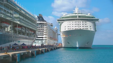 PHILIPSBURG, ST. MAARTEN - 2017: Docked Cruise Ships with Passengers Walking on the Pier Calling at the Popular Caribbean Cruising Destination on a Sunny Day