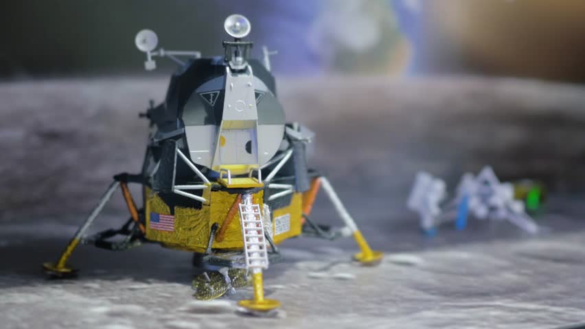 Spaceship on moon.
Astronaut or spaceman working at the back.
