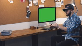 Young adult Caucasian male using holographic augmented reality glasses, creating a model on a computer screen. Green screen chroma key. 4K UHD RAW edited footage - Powered by Shutterstock - Get 15% off with code: PIKWIZARD15