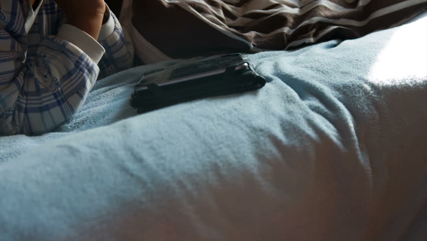 boy in pajamas with a tablet 