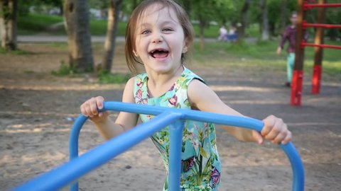 Active Little Child Girl Play On Park Playground Running With A Carousel Slow Motion