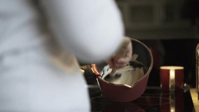 Close up of woman s hands making cream for homemade candy. Locked down real time close up shot
