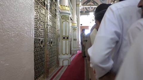 Medina, Saudi Arabia - September 5, 2016: Muslim pilgrims visiting Prophet Mohammad’s holy tomb inside the al-Masjid an-Nabawi. A sacred place for Islam believers to show respect during hajj season.