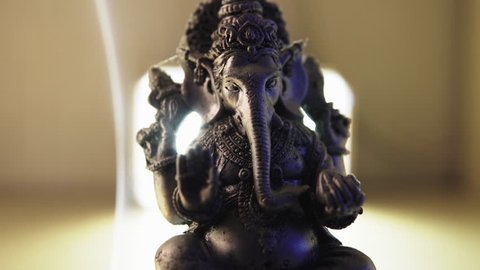 Close-up of the God Ganesh in Hinduism with incense. World religions and Hinduism with Buddhism
 Stock Video