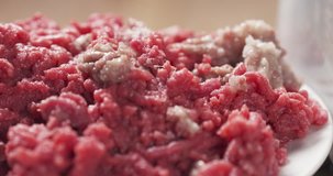Slide shot of raw minced beef with onion, 4k prores footage