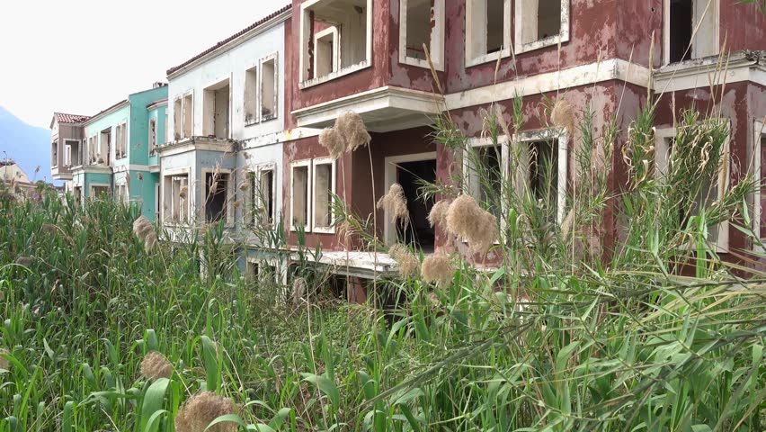 4K Spooky house on marsh overrun with bulrush
