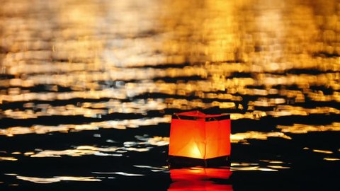 Square floating lighting Lanterns on river at night - romantic festival Stock Video