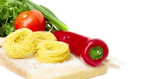 raw pasta nest and ingredients for tomato sauce on white background, 2160p intro motion slow