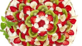 fruit cake with strawberries and kiwi fruit  on white background, 2160p intro motion slow
