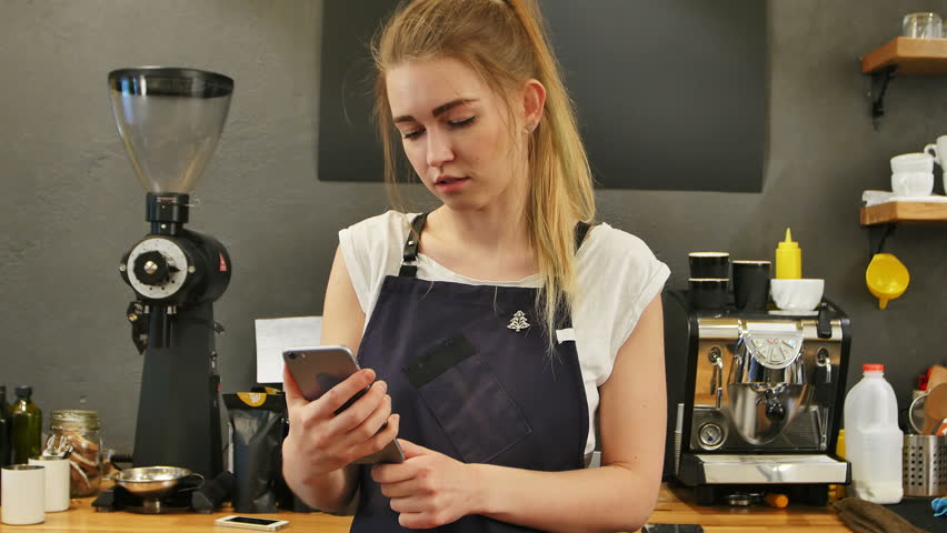 Youg female barista taking selfie at work place
