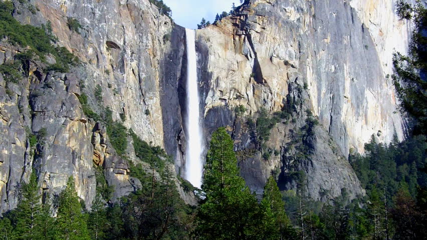 A wide shot of Sentinel Falls plunging from over a sheer granite cliff face in