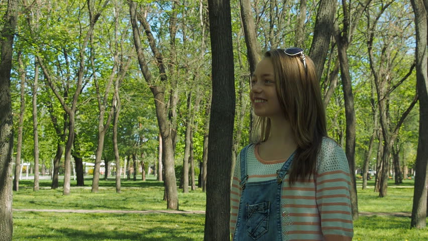 Girl hands catch soap bubbles. A teenage girl in the park. Girl with freckles outdoors.