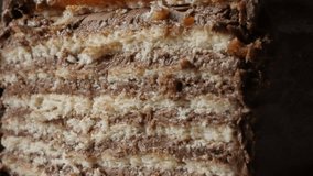 Close-up of different layers of chocolate cake on the plate slow tilt 4K 2160p 30fps UltraHD footage - Tilting on creamy multilayered torte with biscuits 3840X2160 UHD video