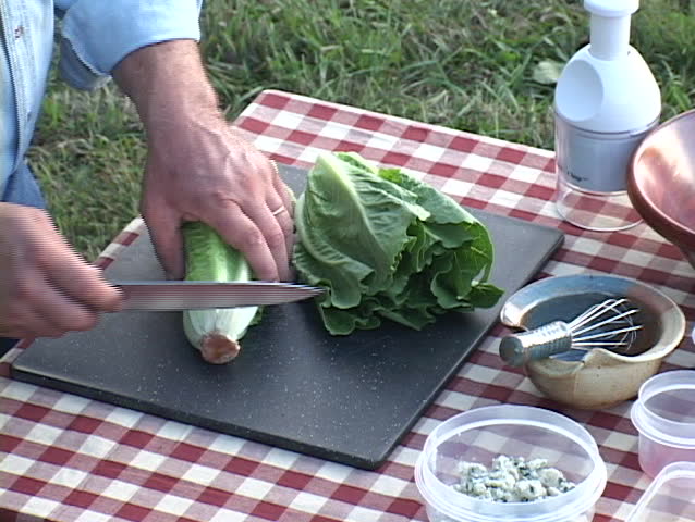 Two heads of Romaine lettuce being chopped