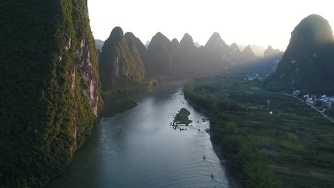 Aerial view of sunset over karst mountain landscape of Yangshuo, Guangxi province, China. Li River and karst mountains top view. Travel, adventure and picturesque famous destination concept