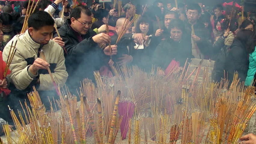 GUANGZHOU - JANUARY 23: People burn incense in temple during Chinese New Year,