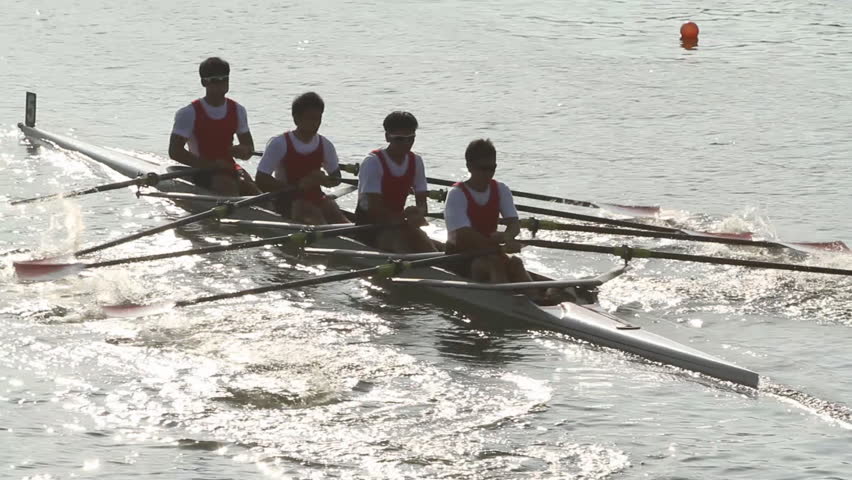 Silhouettes of men's four rowing team at the start of a regatta