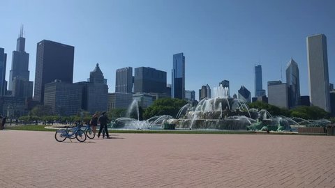 Buckingham Fountain and Chicago Loop Skyline. Divvy bikers visit the iconic fountain in Grant Park while on a leisure bike ride. May 12, 2017
