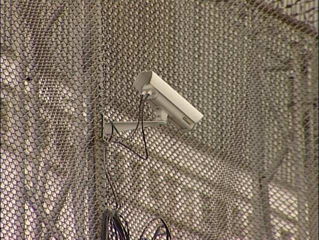 Camera surveillance in prison. (Russian prison). A huge iron fence of metal