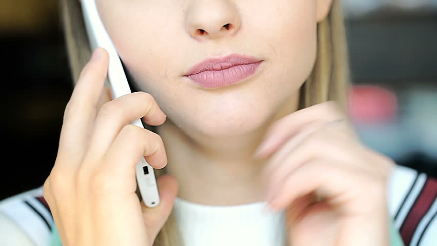 Happy girl with beautiful, natural makeup chatting on cellphone
