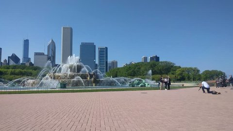 Buckingham Fountain, Pan West. Chicago. May 12, 2017
People visit Buckingham Fountain and take photos. A view of the Loop skyline.
