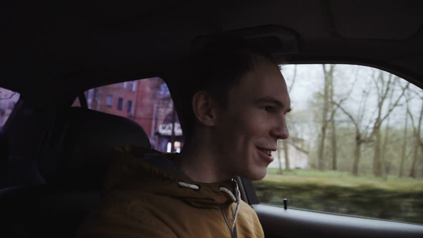 Young man driving a car. Inside shot