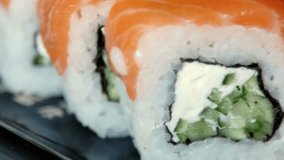 Japanese sushi on black plate. 4K UltraHD video footage