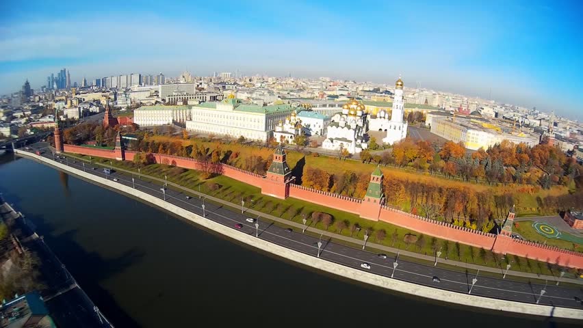 Kremlin Red Square museum Moscow Russia old architecture church complex .Central high wall. Road traffic Embankment. River bridge. City panorama background. Summer blue sky. Aerial drone approach 
