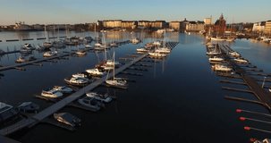 Aerial view drone footage of Helsinki Baltic Sea lagoon area, city skyline with vintage architecture and boats in spring morning, the capital of Finland Suomi, northern Europe