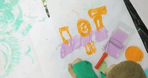 Little child painting the floor, funny boy enjoying to decorate the wall