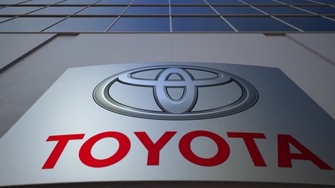 Outdoor signage board with Toyota logo. Modern office building. Editorial 3D rendering