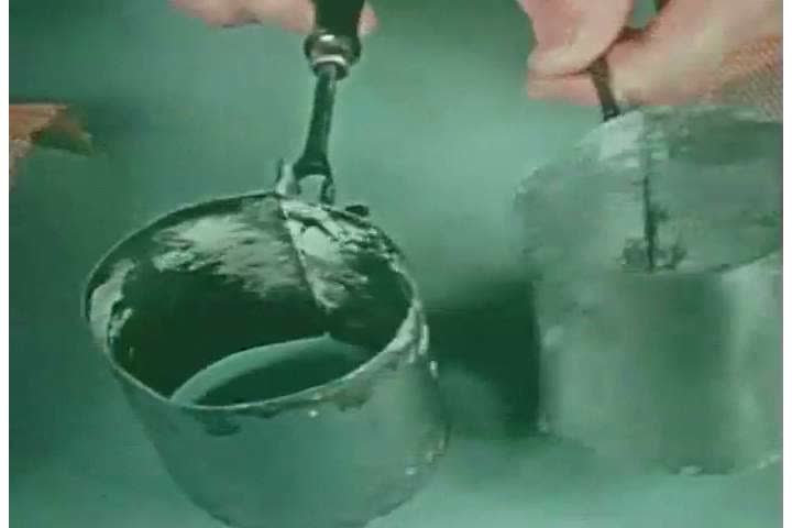 1940s: A dentist shapes molds in containers, with screens, for dentures, in 1944.