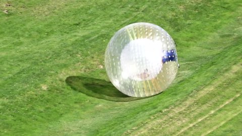 ROTORUA, NZL - APR 25 2017:Visitor rides in ball rolling OGO Zorbing Rotorua.OGO Rotorua is now the only ball rolling operation in New Zealand to be Adventure Activity Safety Audit Certified.